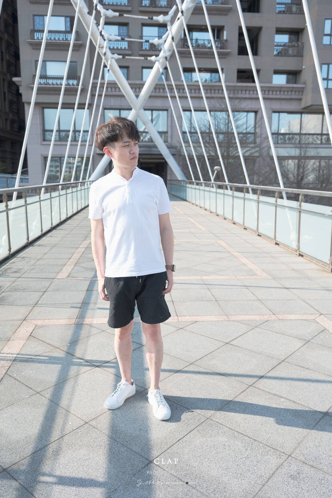 白色亨利領素T搭配黑色短褲，在夏天是很容易上手又實搭的穿搭方式。